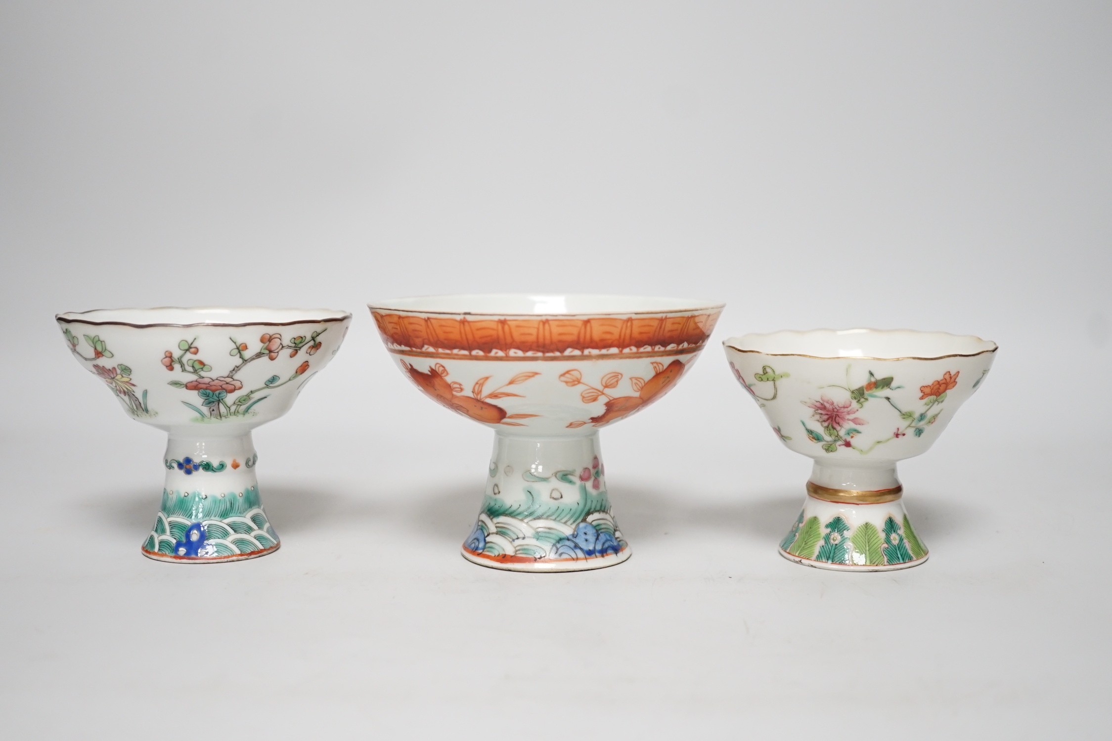 Three 19th century Chinese stem cups, painted with insects, flowers, bats and peaches, largest 9cm